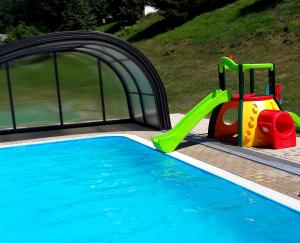 a pool with a slide and a playground at Happy Chalet in Černý Dŭl