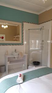 a bathroom with a bed and a shower and a sink at Guest House Frame Ace in Bellville +54 photos