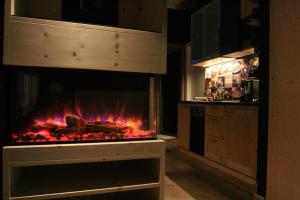 a kitchen with a fireplace with meat in it at B&B Tuscany Gallery in Pisa