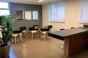 a conference room with a table and chairs and a plant at Agradable Depto. mirando a Clínica Las Condes in Santiago +33 photos