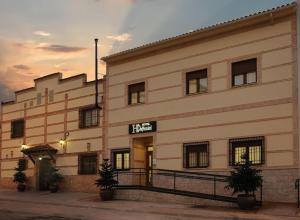 a large white building with a sign on it at Hotel Daymiel in Daimiel