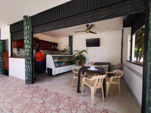 cocina y comedor con mesa y sillas en Hotel Paraiso Plaza, en Puerto Triunfo