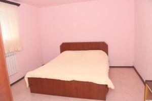 a small bedroom with a bed with a white mattress at Уютные апартаменты в малом центре Еревана in Yerevan