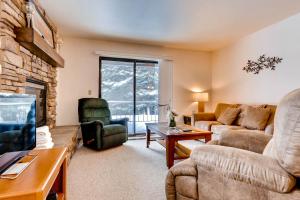 a living room with a couch and a fireplace at Red Pine #B1 in Park City