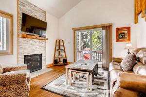 a living room with a couch and a fireplace at Red Pine #K7 in Park City
