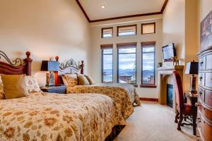 a bedroom with two beds and a fireplace at Hyatt Centric #450 in Park City