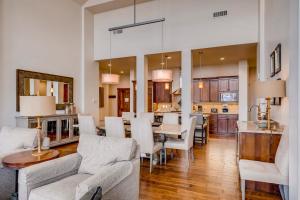 a living room with a dining table and a kitchen at Hyatt Centric #450 in Park City