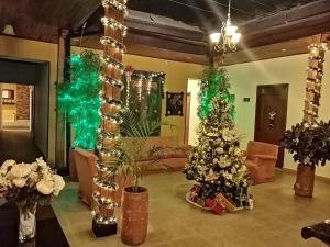 a living room with a christmas tree and christmas decorations at Hotel Plaza Mayor in Duitama