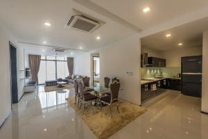 a kitchen and dining room with a table and chairs at Maline Exclusive Serviced Apartments in Phnom Penh