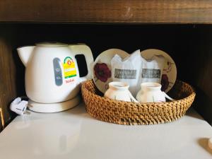 a coffee maker and two baskets on a table at Lanta Nature House in Ko Lanta