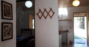 a kitchen with two lights on the wall and a hallway at Casa dos Gatos in Vale do Capao