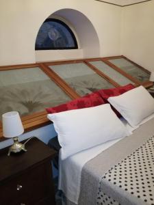 a bedroom with a bed with a window on it at Sweet Sweet Home in Tolve