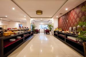 a restaurant with a buffet line with food at Edele Hotel in Nha Trang