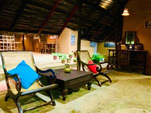 a group of chairs and a table in a room at A4 Villa & Spa. in Habarana