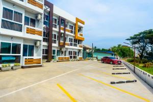 a parking lot in front of a building at O2 Hotel สกลนคร (โรงแรม โอทู สกลนคร) in Sakon Nakhon