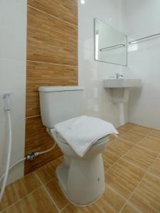 a bathroom with a white toilet and a sink at O2 Hotel สกลนคร (โรงแรม โอทู สกลนคร) in Sakon Nakhon +38 photos