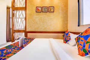 a bedroom with a bed and a window at FabHotel The Khushi Regent in Bhopal