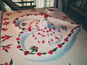 a white cake with red flowers on a table at Punnamada Resort in Alleppey