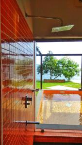 a glass door with a view of a pool at Punnamada Resort in Alleppey