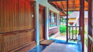 an open door to a house with a porch at Punnamada Resort in Alleppey