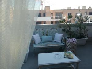 a bench sitting on a balcony with a table at Airport & Fair Suite Apartments in Fiumicino