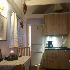 a kitchen with a table with a candle on it at Kleines Haus am Hafen - ruhig und grün am Ortsrand in Prerow +17 photos