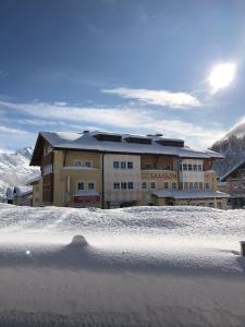 a building with snow in front of it at Apparthotel Samson in Obertauern