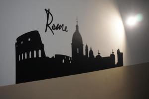 a black silhouette of a city on a wall at VMH Vatican Modern House in Rome