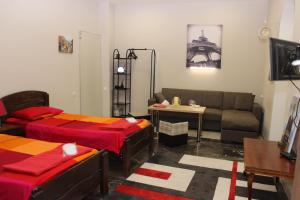 a living room with two beds and a couch at Luka Apartment in Tbilisi City