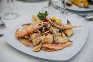 a plate of food on a table at Hotel Corallo in Francavilla al Mare