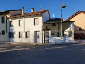 a white building on the side of a street at HAPPY HOUSE MORSANO in Morsano al Tagliano