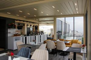 a restaurant with tables and chairs and a kitchen at Corner Hotel Laleli in Istanbul