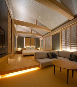 a living room with a couch and a bed at Campton Kiyomizu Vacation Rental in Kyoto