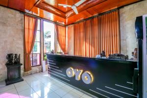 a bar in a room with orange curtains at SUPER OYO 1952 Hotel Dewata Indah in Denpasar