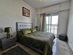 a bedroom with a bed and a large window at Blume Apartment Casa Port - 2 Bedrooms in Casablanca