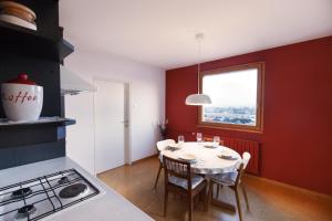 eine Küche mit einem Tisch mit Stühlen und einem Fenster in der Unterkunft Bright Penthaus Apartement, with a wonderful view in Ljubljana