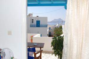 a view from a door of a balcony with a table at Aegeon Pension in Aegiali