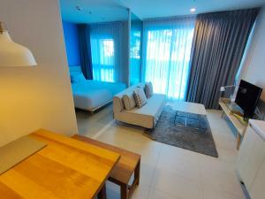 a living room with a couch and a table at BLU-Pool Access in Cha Am