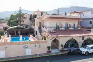 a house with a car parked in front of it at Erato Hotel in Kokkini Khanion