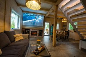 a living room with a couch and a fireplace at Relax House Narty in Narty