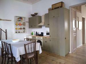 a kitchen with a table and some chairs and a table and a kitchen with at En Patmo Holiday Home in Patmos