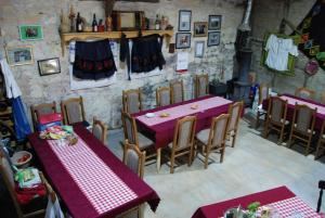 a restaurant with purple tables and chairs in a room at "Pivnica i smestaj Jovanovic"- Rogljevacke pivnice in Rogljevo
