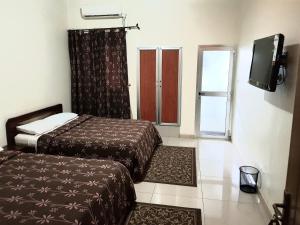 Ein Bett oder Betten in einem Zimmer der Unterkunft Hotel du Golfe de Guinee