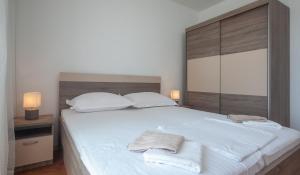 Postel nebo postele na pokoji v ubytování Apartments Gaston