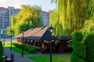 un cenador en un parque con árboles y luces en Hotel Complex Legenda, en Ivano-Frankivsk