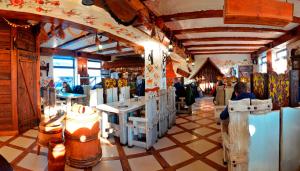 a man sitting at a table in a restaurant at Hotel Complex Legenda in Ivano-Frankivsk
