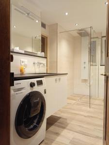 a washing machine in a bathroom with a shower at Ferienwohnung Schmallenberg in Schmallenberg