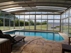 a swimming pool in a building with windows at Aguas del Monte Hotel SPA in San Miguel del Monte +46 photos
