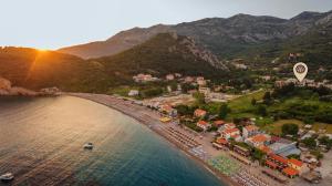 an aerial view of a beach with a town and a hot air balloon at Apartments Viktorija in Petrovac na Moru