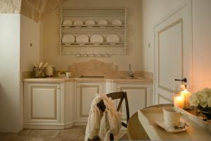 a kitchen with a table and a counter top at Hotel Don Ferrante in Monopoli